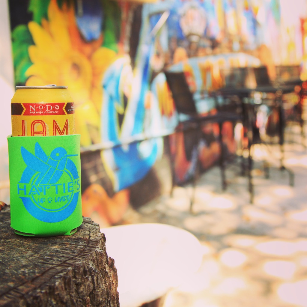 outdoor patio with colorful mural and craft beer